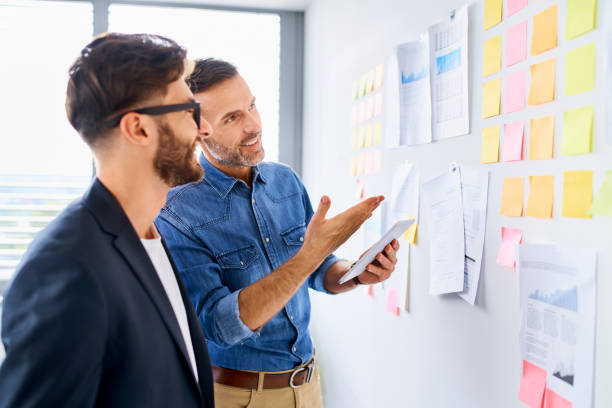 istock Two businessmen discussing project at modern office during meeting 1281495029