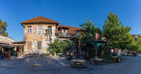 Ljubljana, Slovenia - August 21, 2020: A panorama picture of some buildings and sculptures at the Metelkova Art Center.