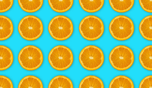 istock Top view of half cut oranges fruit on blue background with clipping path 1281499400