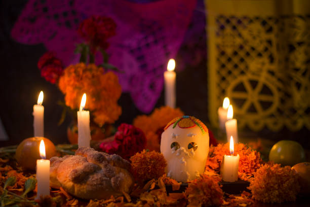 Day of the dead altar for mexican celebration Mexican traditional altar for day of the day celebration with sugar skull, bread, yellow cempasuchil flowers and candle light day of the dead photos stock pictures, royalty-free photos & images