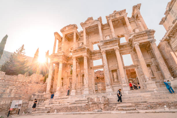Sunset at the Library of Celsus in Ephesus Ancient City Selcuk, İzmir , TURKEY - October 18 2020:  Celsus Library is one of the most beautiful structures in Ephesus. Celcius Library was built in 117 A.D. Celsus Library was a monumental tomb for Gaius Julius Celsus Polemaeanus, the governor of the province of Asia; from his son Galius Julius Aquila. The grave of Celsus was beneath the ground floor, across the entrance and there was a statue of Athena over it. celsus library photos stock pictures, royalty-free photos & images