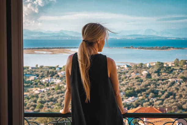 istock Young woman on seaside hotel balcony 1281500074