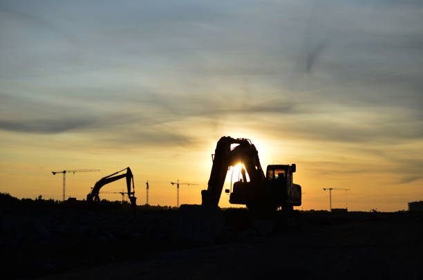 istock Excavator with hydraulic shears at construction site on sunset background 1281501491