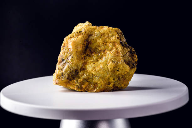 uranium ore, on electronic scale. Metal used in industry. Mineral extraction concept.
