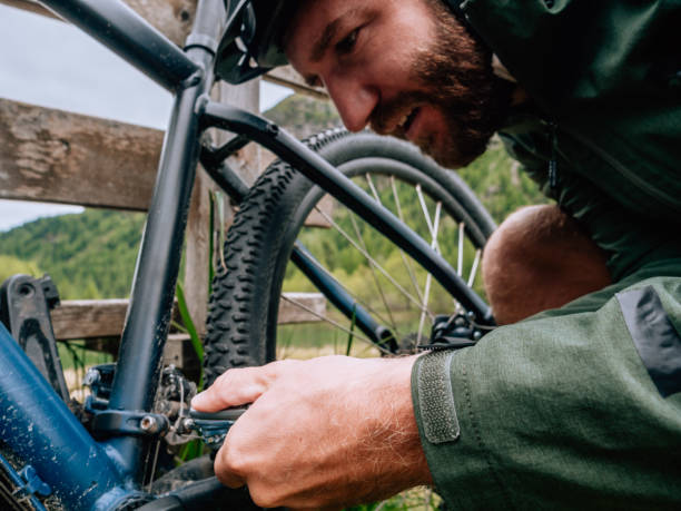 istock Man fixing mountain bike on trail 1281504223