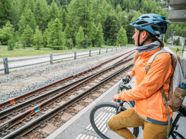 Woman with mountain bike waiting for public transportation