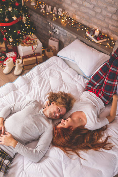 istock Couple lying upside down in bed on Christmas morning 1281504635
