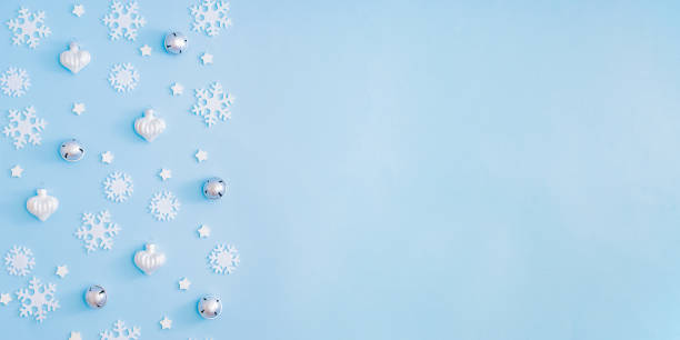 istock Flat lay border with christmas balls and snowflakes on a blue background 1281504898