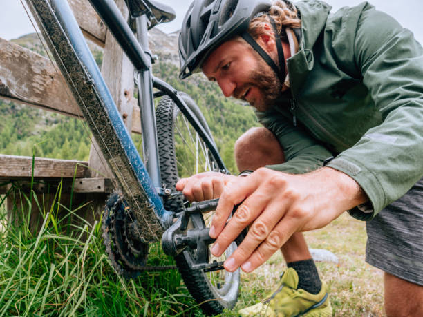 istock Man fixing mountain bike on trail 1281505722