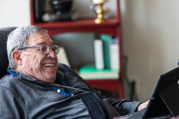 istock Senior man relaxing and having a good time while sitting in a recliner and watching funny content on his tablet. 1281506030