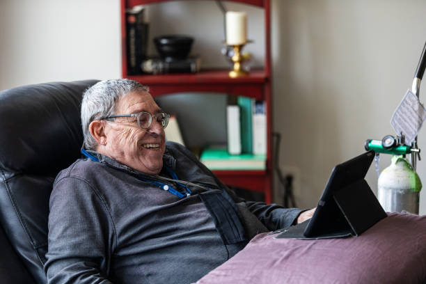 istock Senior man relaxing and having a good time while sitting in a recliner and watching funny content on his tablet. 1281506051