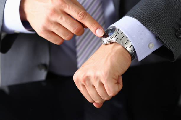 istock Businessman is checking time on his wristwatch 1281507199