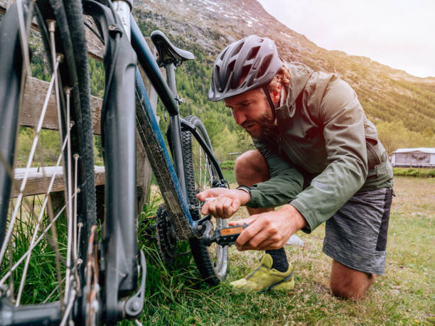 istock Man fixing mountain bike on trail 1281507207