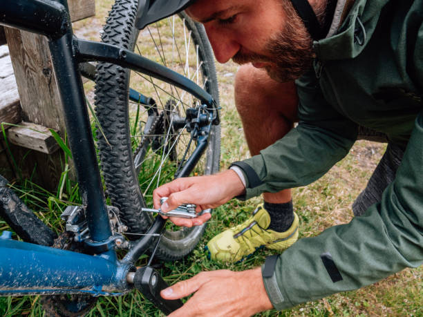 istock Man fixing mountain bike on trail 1281507335