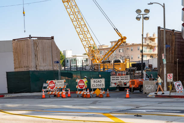 Los Angeles, California - October 16 2019: Construction site on sunny day on Wilshire Boulevard, Los Angeles, California. Professional engineering project with heavy duty crane & road closure signs in the modern city.