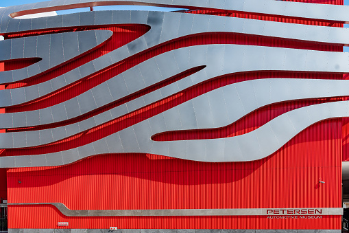 Los Angeles, California - October 16 2019: Petersen Automotive Museum, a non profit automobile history organization with unique wavy red and silver exterior wall design, in Los Angeles, California.