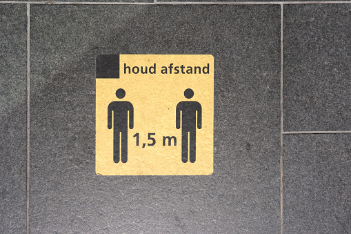 Caution sign board on stair floor at train station with a Dutch word \