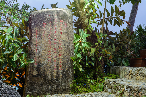 Sanya, Hainan, China - February 19, 2020: Stone with hieroglyphs at night in Luhuitou Park, Sanya, island Hainan, China