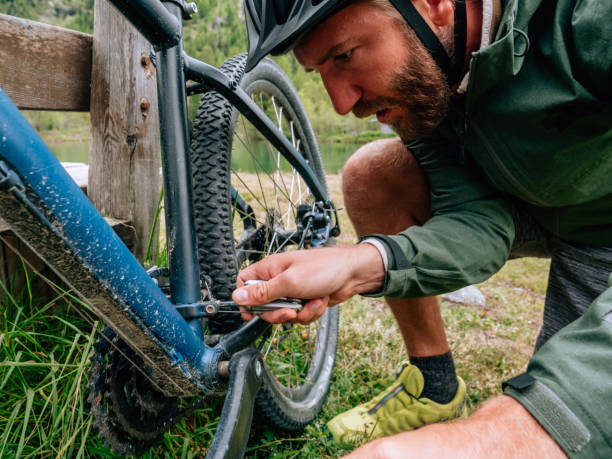 istock Man fixing mountain bike on trail 1281508911