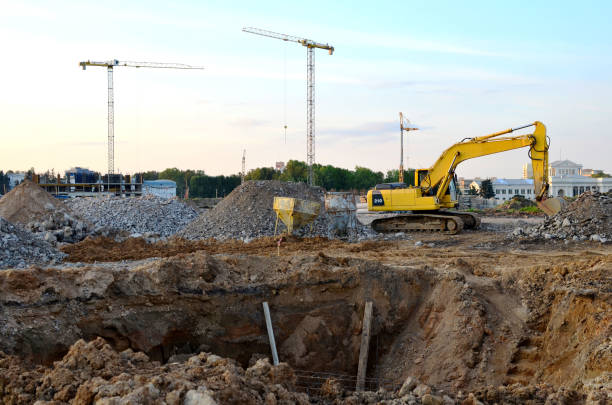 istock Tracked excavator working at a construction site during laying or replacement of underground storm sewer pipes 1281509175