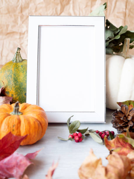 istock Empty photo frame on autumn background with decorative pumpkins 1281511699
