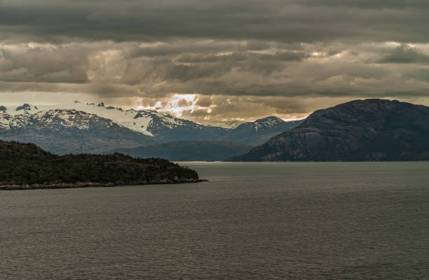 istock Glacier on mountain under dark cloudscape in Sarmiento Channel, Chile. 1281514125