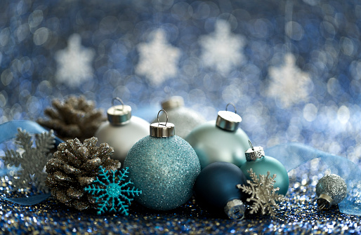 Christmas Blue Baubles and Snowflakes on a Blue Background. Very Shallow Depth.