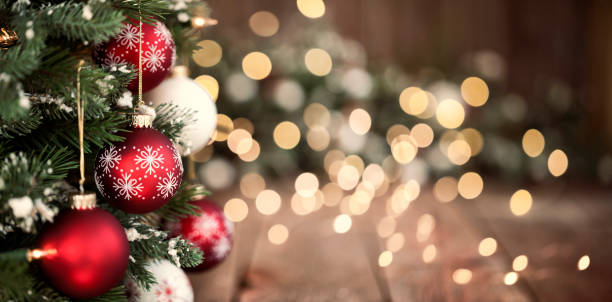 istock Christmas Tree, Red and White Ornaments against a Defocused Lights Background 1281515241