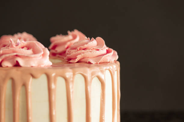 istock Pink birthday cake over a black background 1281515656