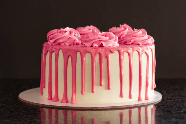 istock Pink birthday cake over a black background 1281515669