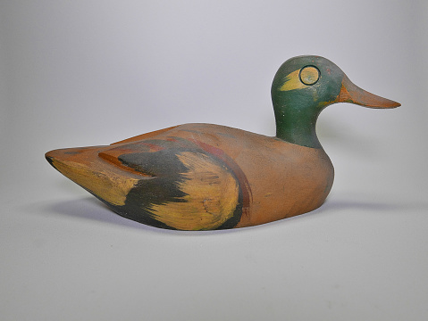 Wooden duck decoy on white background