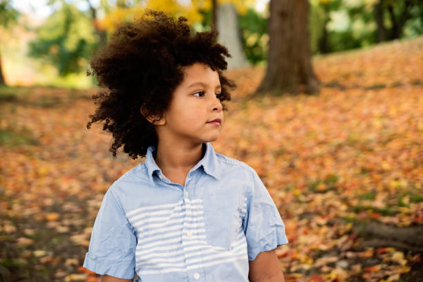 istock Mixed-race young boy enjoying autumn in urban park. 1281516640