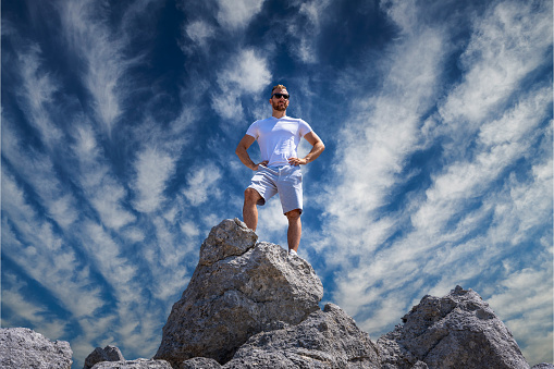 Guy with hands on his waist confidently looking into the distance