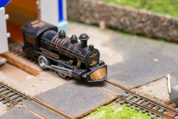 istock Railway modelling. Close-up about model train on the rail tracks. 1281520315