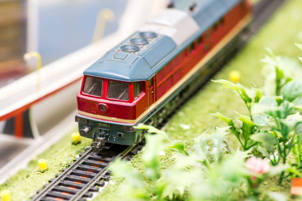 istock Railway modelling. Close-up about model train on the rail tracks. 1281520764