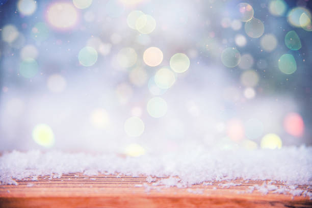 Empty rustic wooden table with blurred Christmas lights in the background
