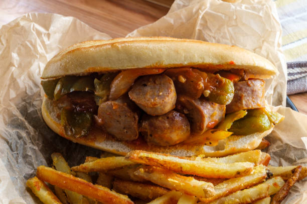 Sausage Onion Peppers Bun Fried sausage onions and red green and yellow bell peppers on sandwich bun torpedo sandwich stock pictures, royalty-free photos & images