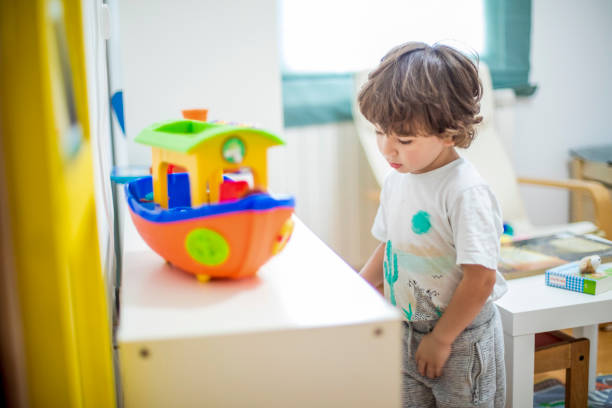 istock Beautiful toddler boy playing with his toys. 1281521981