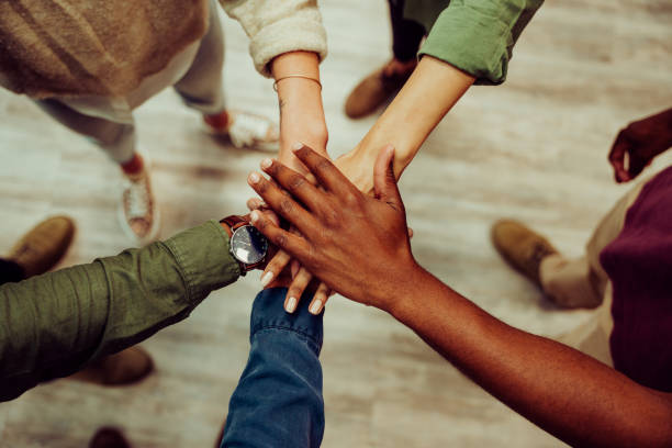 istock Successful business group hands stacked together showing unity and team work 1281522128