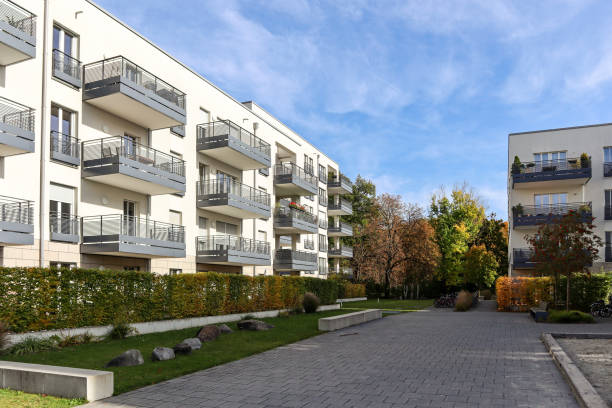 Cityscape with modern residential area, new apartment buildings and green courtyard with pedestrian walkway and trees in autumn Cityscape with modern residential area, new apartment buildings and green courtyard with pedestrian walkway and trees in autumn green building blocks stock pictures, royalty-free photos & images