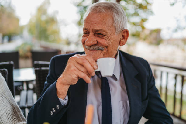 istock Senior man enjoying cup of coffee in sidewalk cafe 1281526061