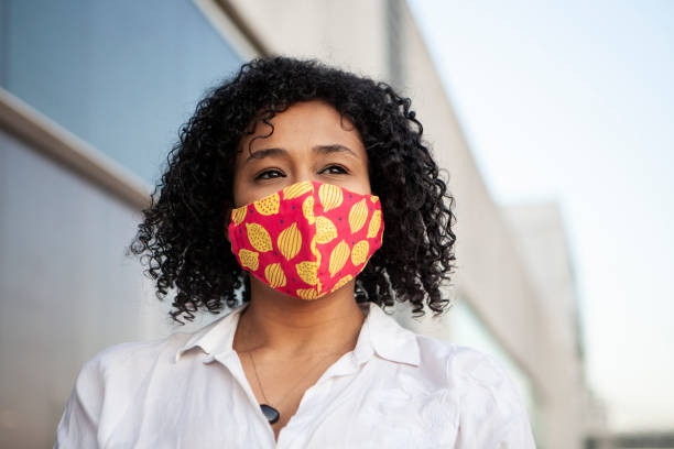 istock Afro black woman smiling with protective face mask 1281527177