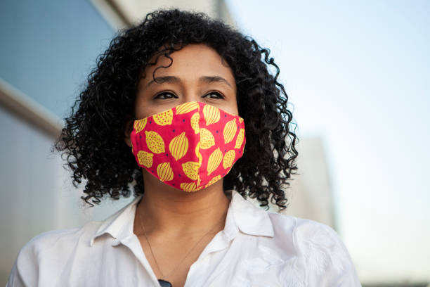 istock Afro black woman smiling with protective face mask 1281527212