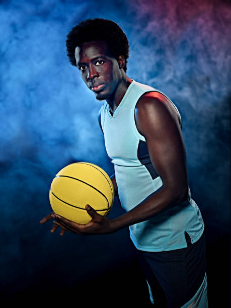istock young african basketball player man isolated black background 1281528206