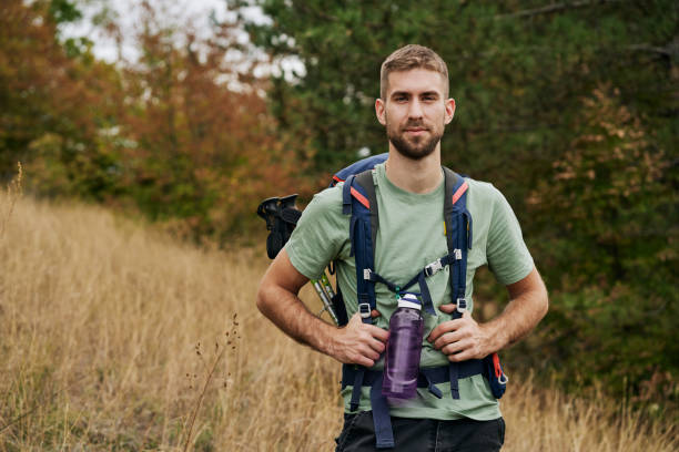 istock Handsome and confident backpacker hiking in nature 1281528388