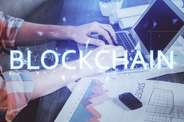 istock Crypto currency theme hologram with businessman working on computer on background. Concept of blockchain. Multi exposure. 1281529071