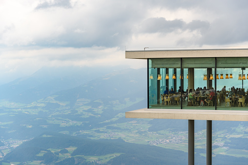 Kronplatz, Italy - August 28, 2020: Restaurant at the Lumen Museum of Mountain Photography on Kronplatz, Alto Adige. Built in 2017, the House of Mountain Photography includes a number of event and meeting rooms, as well as the AlpiNN  restaurant.