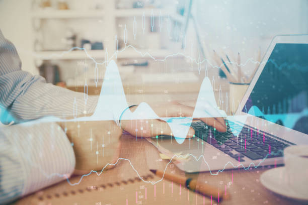 istock Multi exposure of stock market chart with man working on computer on background. Concept of financial analysis. 1281529136