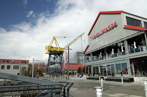 North Vancouver, Canada - October 13, 2020: Quiet day with few visitors exploring The Shipyards District Lower Lonsdale during COVID-19. This revitalized business center includes restaurants, stores and hotels. A yellow industrial crane is a historic reminder of the original shipyards along the north waterfront of Burrard Inlet.