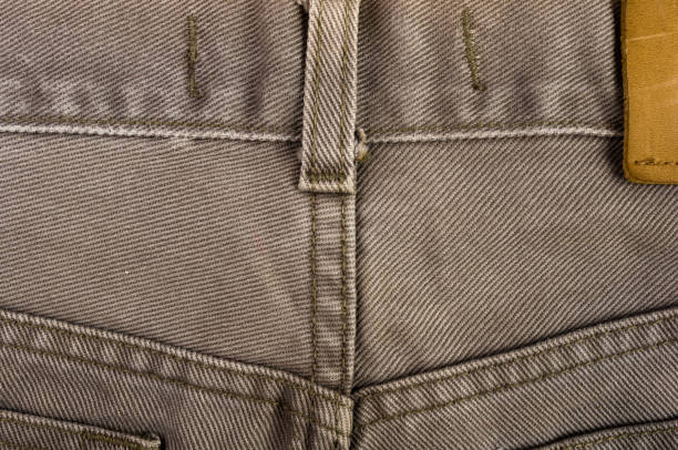 istock clothing items stonewashed cotton fabric texture with seams, clasps, buttons and rivets, macro 1281530912